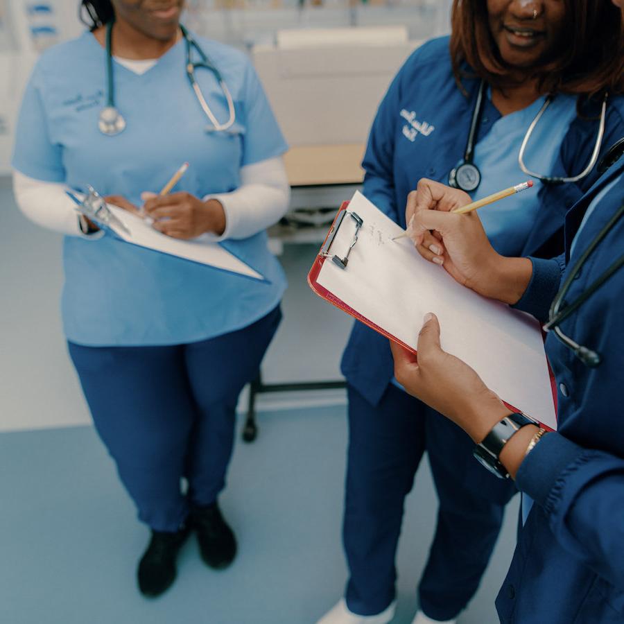 Nursing students on clipboard